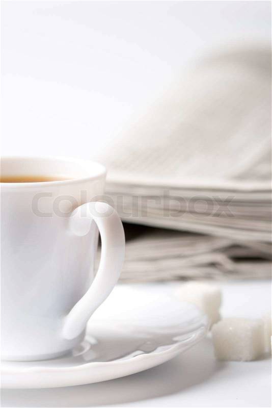 Cup of coffee, sugar and stack of newspapers closeup, stock photo