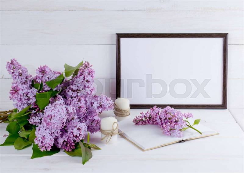Lilac bouquet with motivational frame for your text or picture on background of white wooden planks in scandinavian style, stock photo