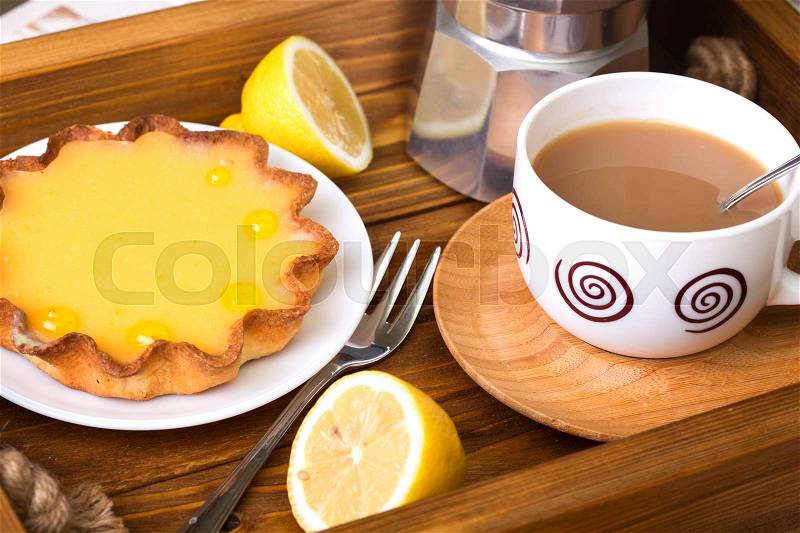 Breakfast - a tray of lemon tarts and coffee , stock photo