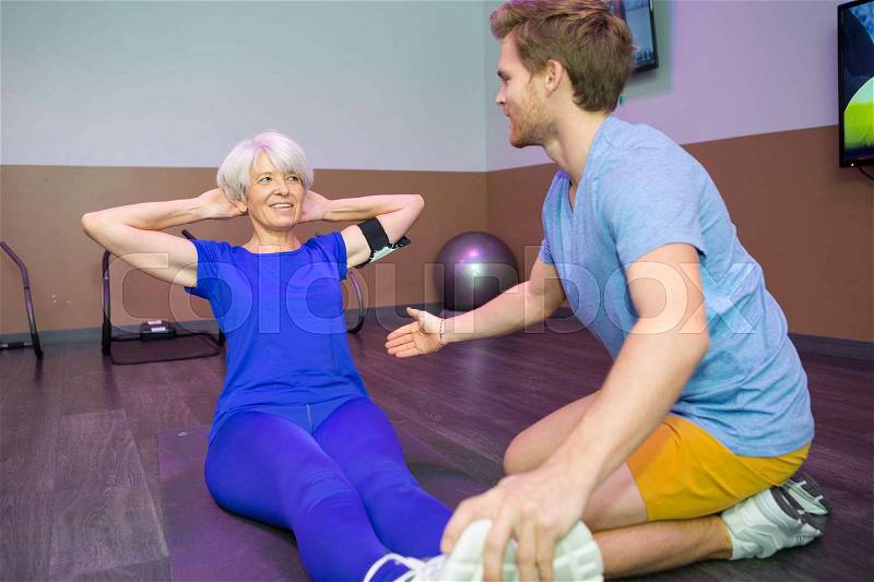 Work out fitness old woman doing sit ups abs abdominal, stock photo