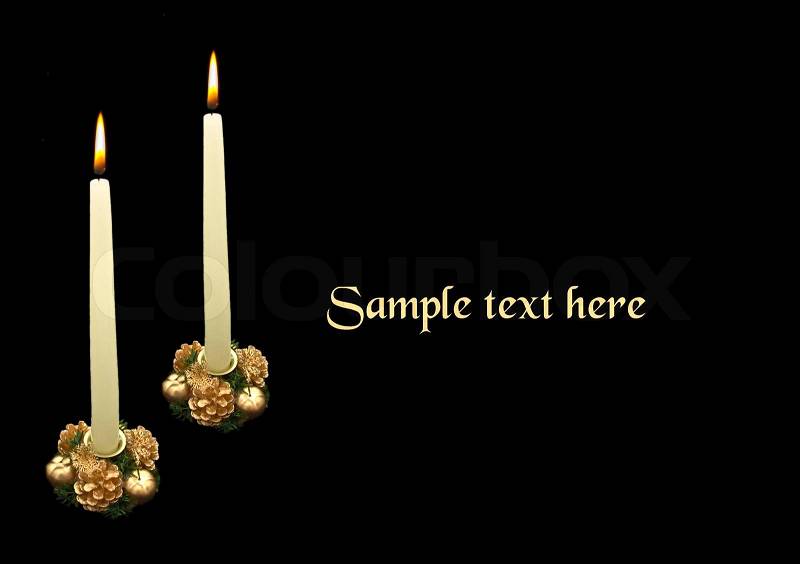 Two christmas candles on black background, stock photo