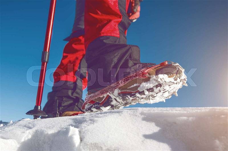 View of walking on snow with Snow shoes and Shoe spikes in winter. Vintage tone, stock photo