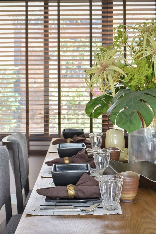 Elegant table set in oriental style dining room interior, stock photo
