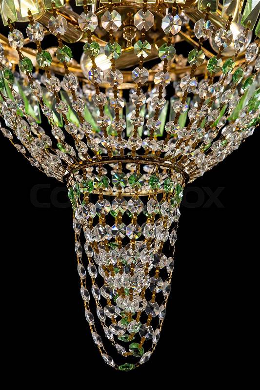 Large chandelier with green crystals close-up in baroque style isolated on black background. Luxury royal expensive chandelier for living room, Hall of celebration, stock photo