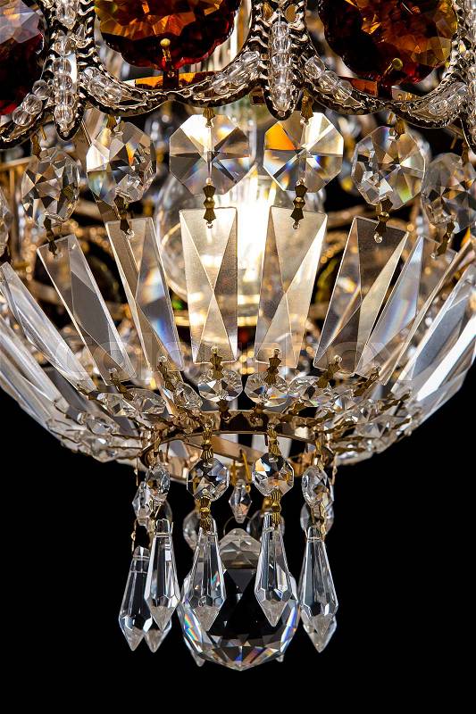 Large crystal chandelier close-up in baroque style isolated on black background. Luxury royal expensive chandelier for living room, Hall of celebration, stock photo