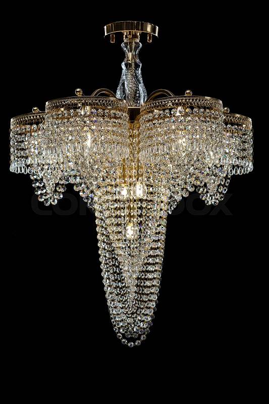 Large crystal chandelier isolated on black background. Luxury royal expensive chandelier for living room, Hall of celebration, stock photo