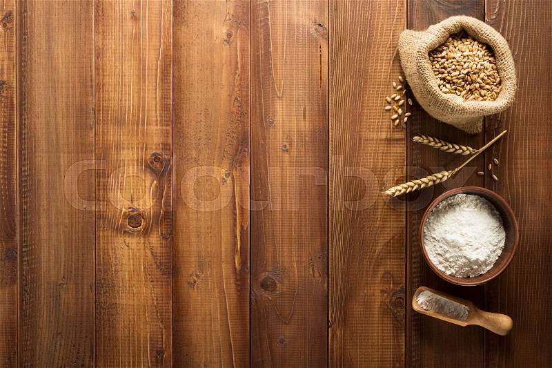Bakery ingredients on wooden plank background, stock photo