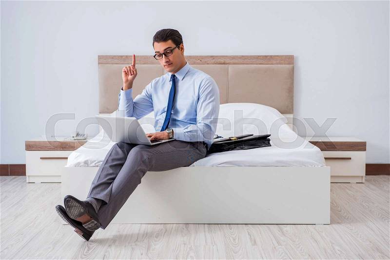 Businessman in the hotel room during travel, stock photo