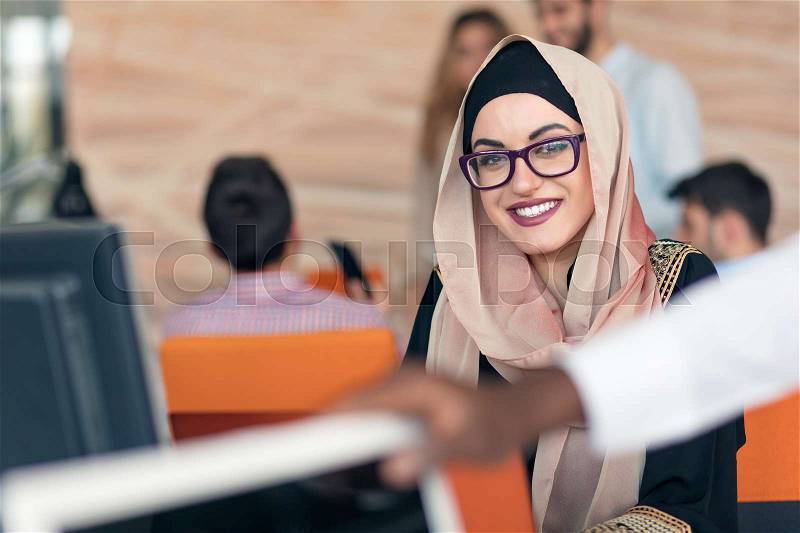 Young Arabic business woman wearing hijab,working in her startup office, stock photo