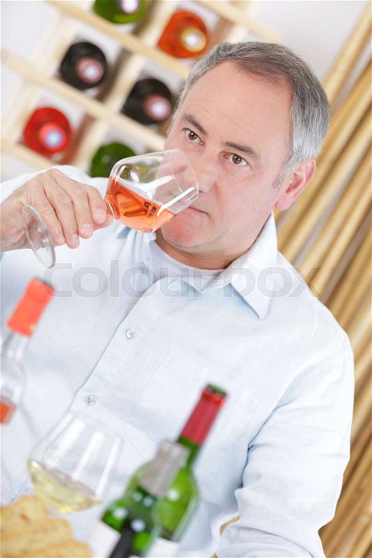 Man giving a mark to a wine, stock photo