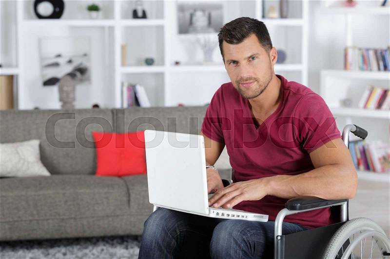 Disabled woman using a laptop computer, stock photo
