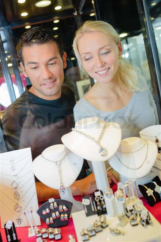 Stylish couple shop window jewelry shop, stock photo