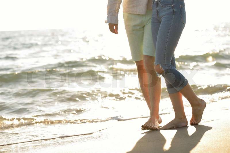 Legs of couple on the sand beach, stock photo