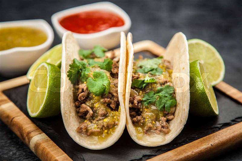 Mexican tacos with beef and green salsa, stock photo