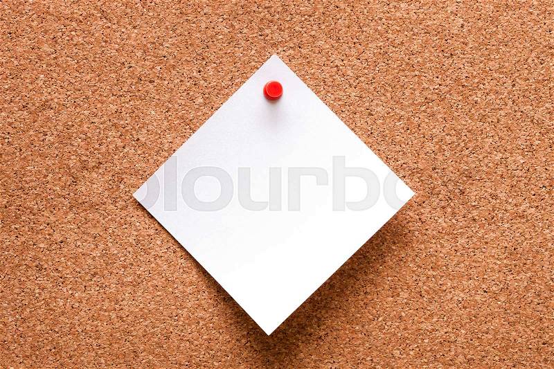White paper with red clip nailed on wooden board, stock photo