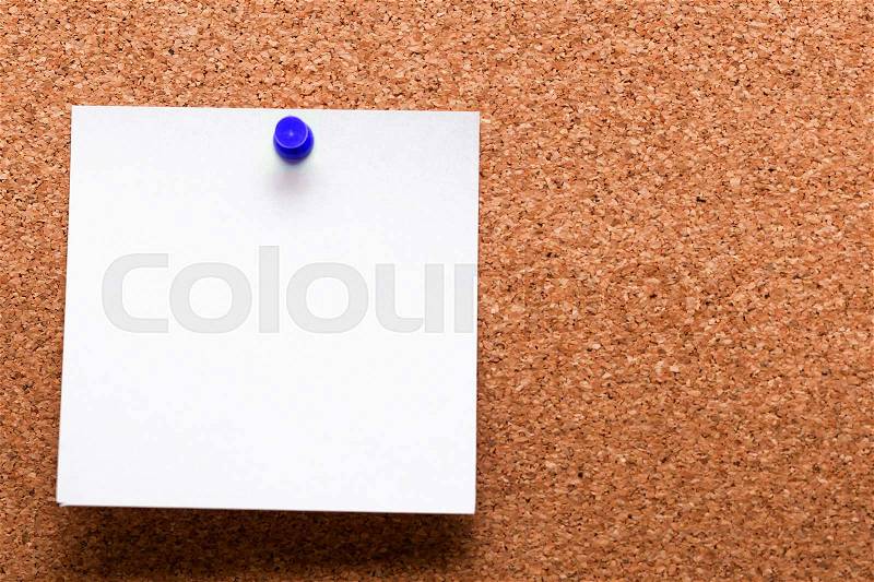 White paper with blue clip nailed on wooden board, stock photo