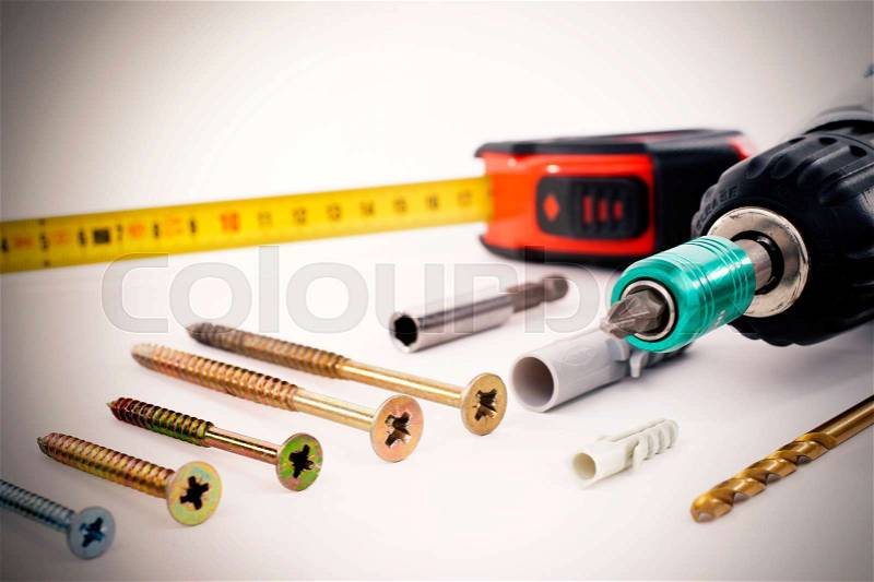Cordless Screwdriver and Tools on wooden Background, stock photo