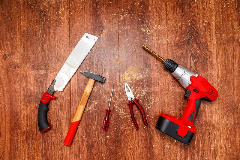 Cordless Screwdriver and Tools on wooden Background, stock photo
