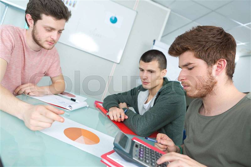 Students working with tables graphs diagrams makes calculations, stock photo