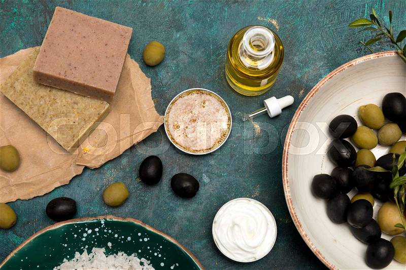 Close-up view of sea salt, handmade soap and olives for homemade cosmetics , stock photo