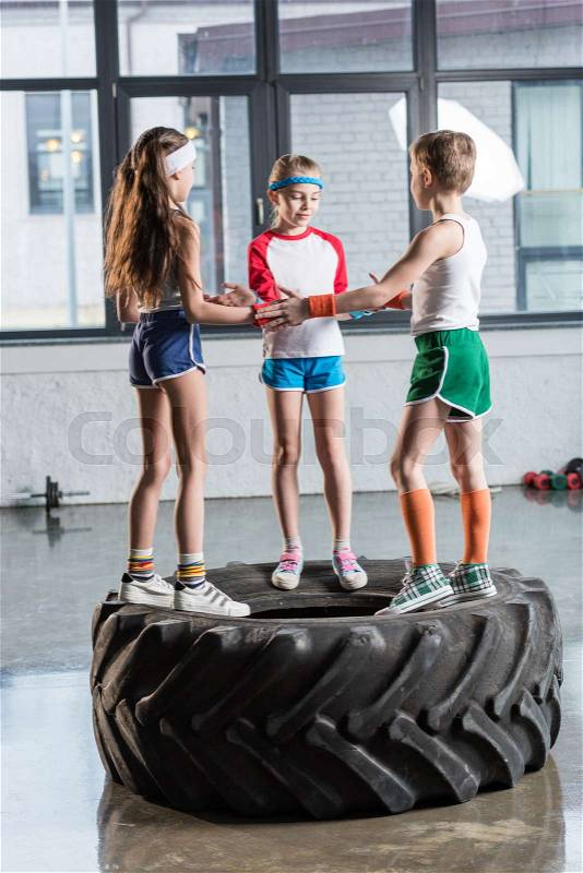 Adorable funny kids in sportswear playing at fitness studio, children sport concept, stock photo