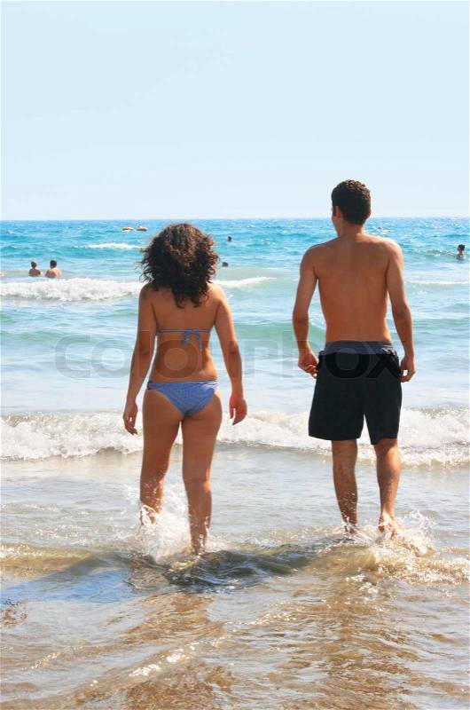 Couple walking to the sea, stock photo