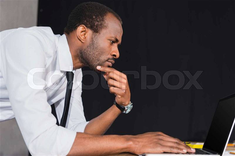 Professional architect in formal wear working with laptop at modern office, stock photo
