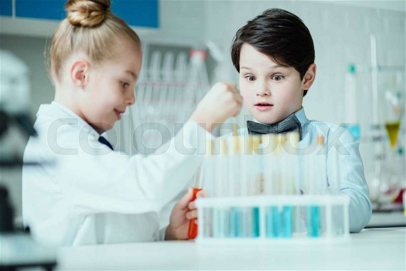 Schoolchildren with science lab equipment in chemical lab, science school concept, stock photo