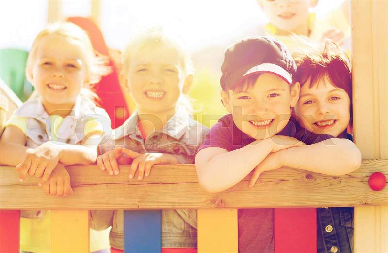Summer, childhood, leisure, friendship and people concept - group of happy kids on children playground, stock photo