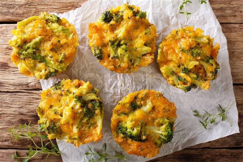 Broccoli bites with cheddar cheese, egg and thyme close-up on the table. horizontal view from above , stock photo