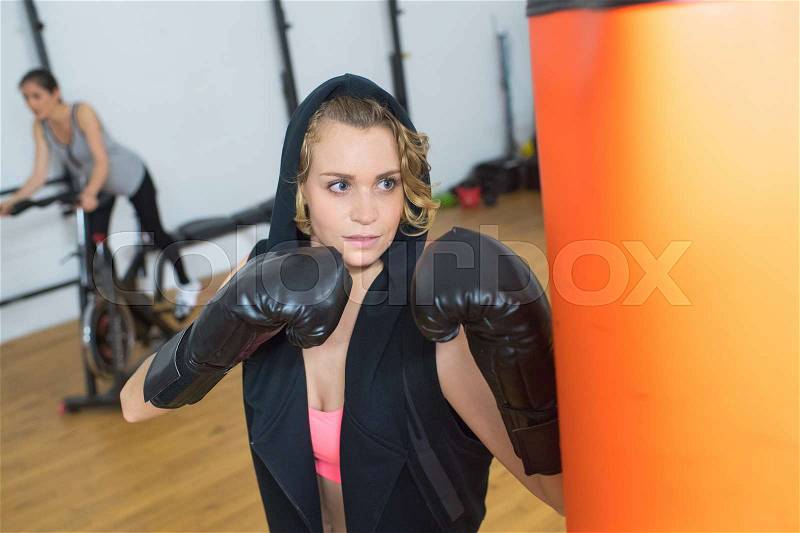 Beautiful woman ready to fight at gym, stock photo