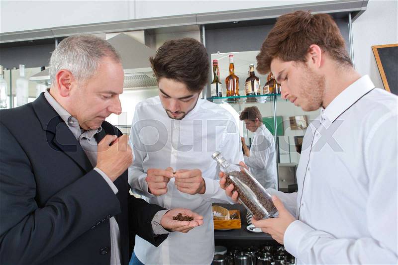 Roasted coffee being smelled by restaurant staff, stock photo