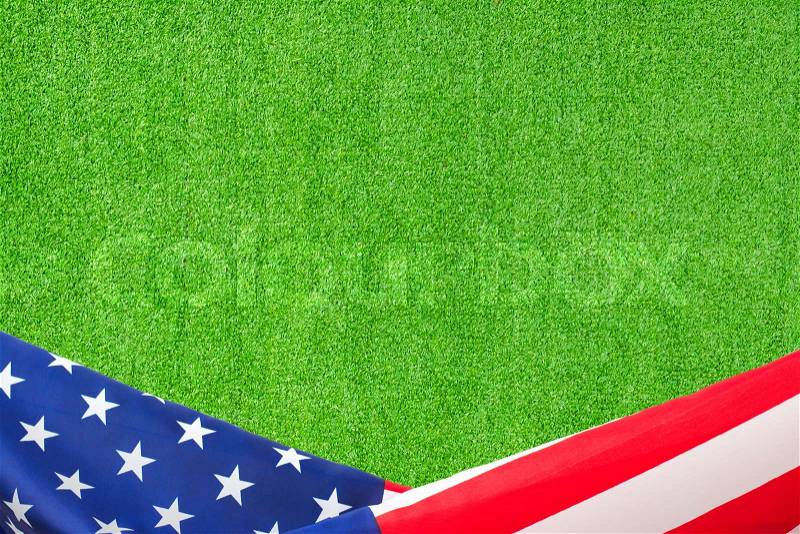 US flag border on artificial green grass background, stock photo