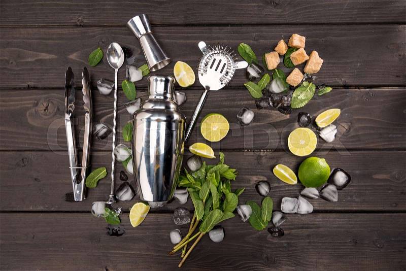 Top view of mojito cocktail ingredients and utensils on wooden table top, cocktail drinks concept, stock photo