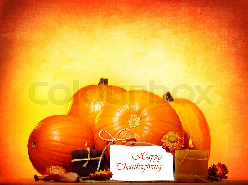 Happy thanksgiving day greeting card with traditional pumpkin and candles, holiday table setting, stock photo
