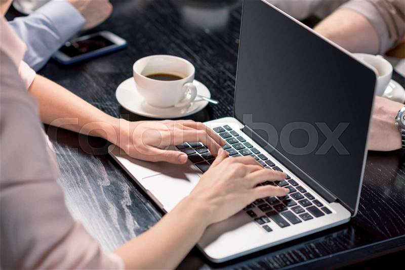 Cropped shot of person using laptop on lunch meeting in cafe, business lunch concept, stock photo