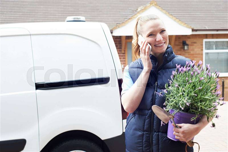 Woman Running Mobile Gardening Business Using Mobile Phone, stock photo
