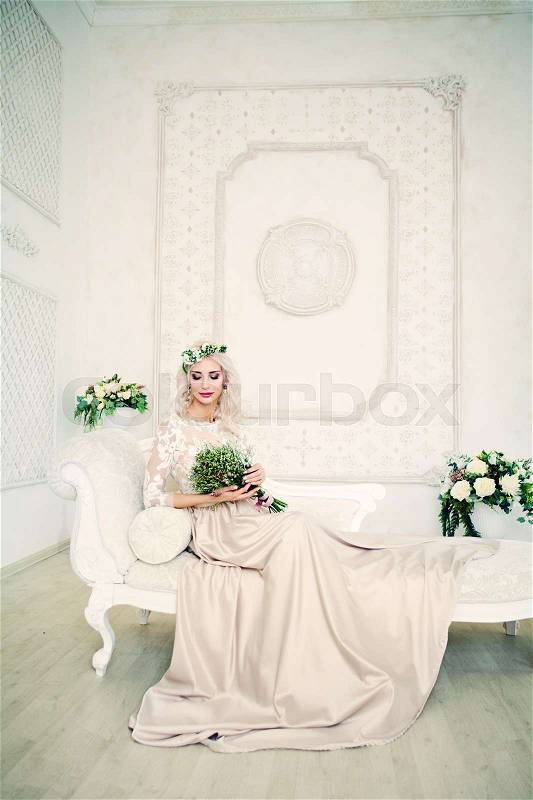 Perfect Model Woman in Evening Gown Sitting on the Sofa, stock photo