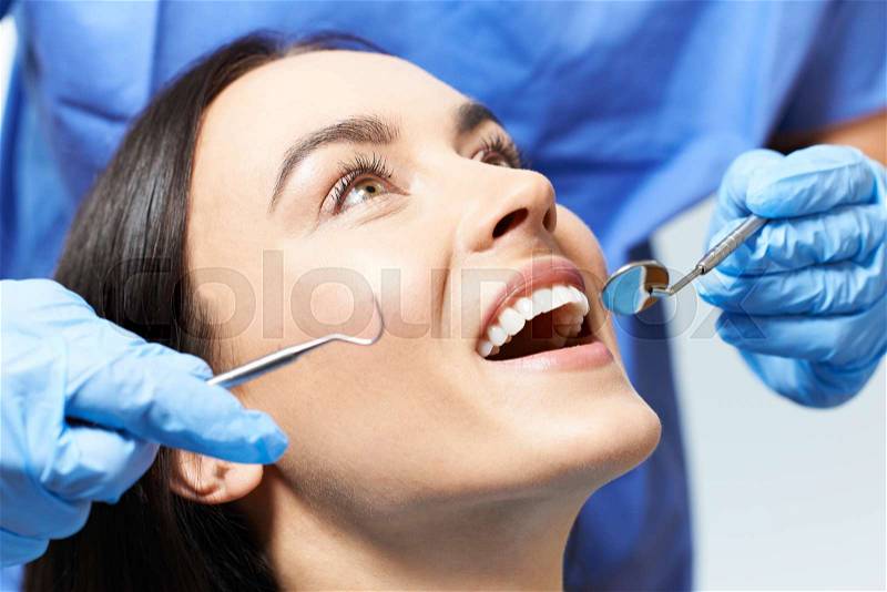 Young Woman Having Check Up And Dental Exam At Dentist, stock photo