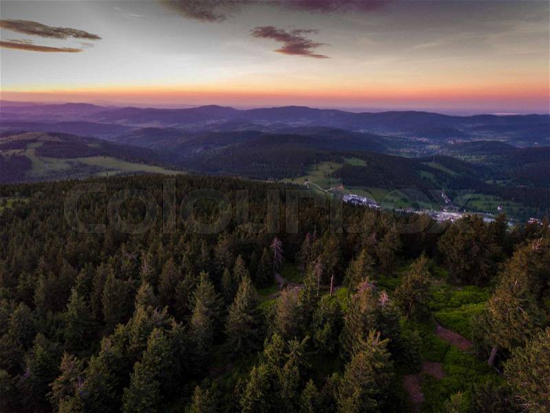 Sunset. Aerial view of the summer time in mountains near Czarna Gora mountain in Poland. Pine tree forest and clouds over blue sky. View from above, stock photo