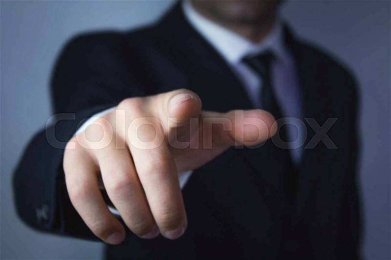 Businessman pointing finger at you, stock photo