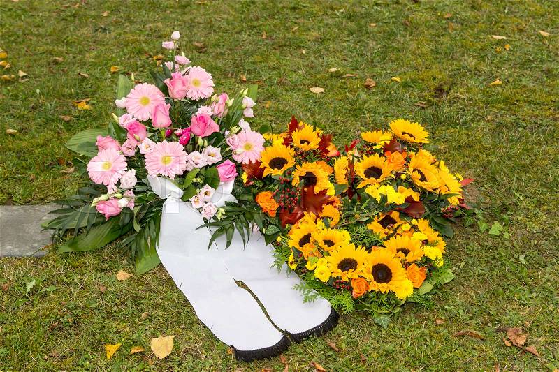 Beautiful floral arrangements on a funeral on meadow, stock photo