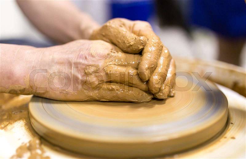 The master makes by hands the product of dishes from clay, stock photo