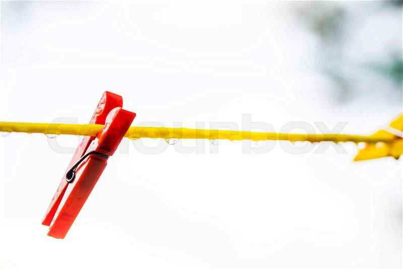 Clothes line with pegs after rain, stock photo