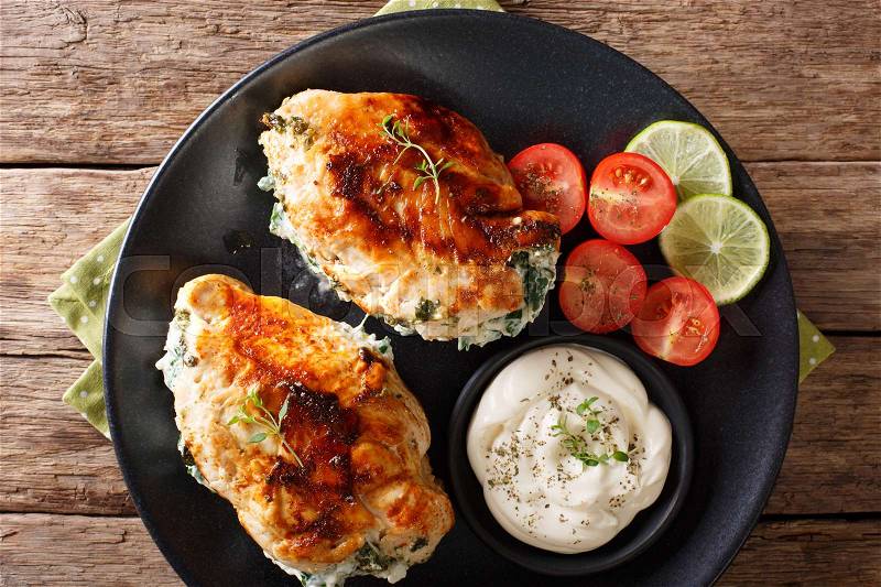 Delicious food: Baked chicken fillet stuffed with cheese and spinach close-up on a plate. horizontal view from above , stock photo