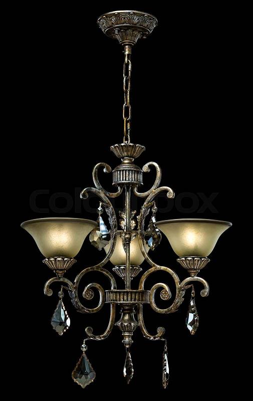 Black ancient chandelier for bedroom isolated on black background. Chandelier lamp with candles for the living room interior, stock photo
