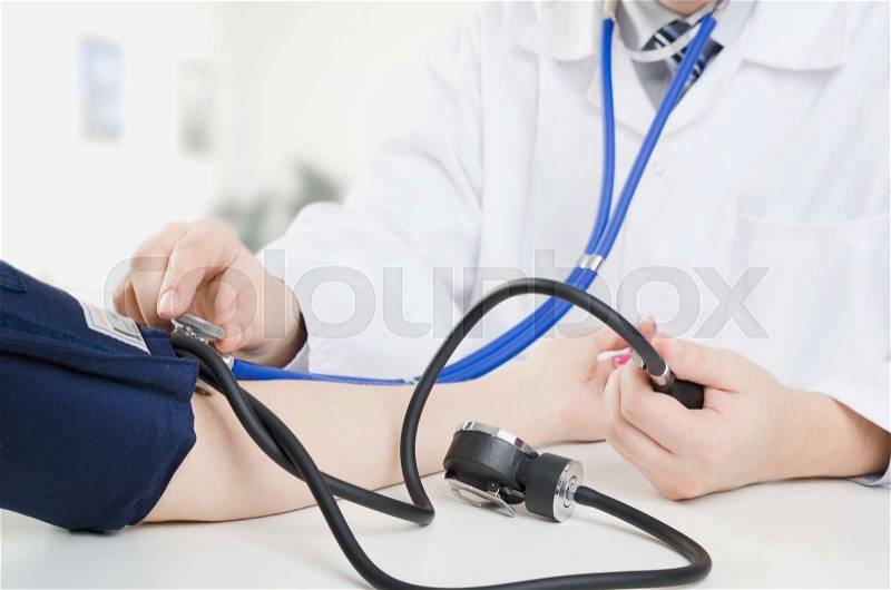 Doctor measures the pressure of the patient. doctor patient blood pressure clinic sphygmomanometer medical worker concept, stock photo
