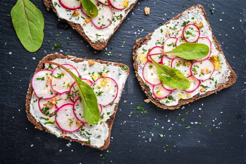 Delicious sandwiches with soft cream cheese and radish. Vegetarian food, stock photo