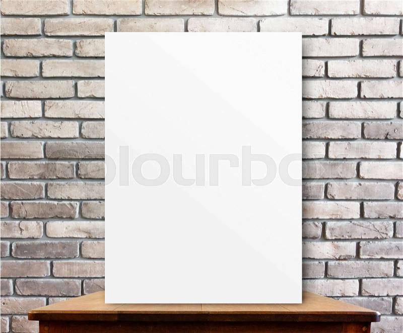 Blank poster on wood table at brick wall,perspective background, stock photo