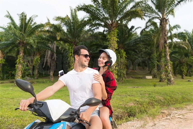 Couple Riding Motorbike, Young Man And Woman Travel On Bike On Tropical Forest Road During Exotic Summer Holiday, stock photo